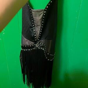Black Lustre spandex halter dress with an attached fringe skirt.